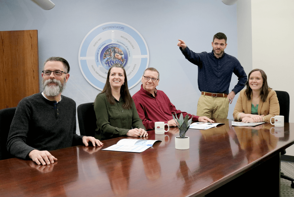 Stanley Consultants members highlighting ownership in a conference room