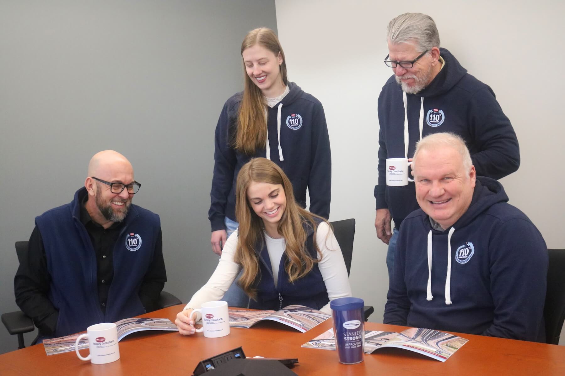 Stanley Consultants' team members reviewing a pamphlet