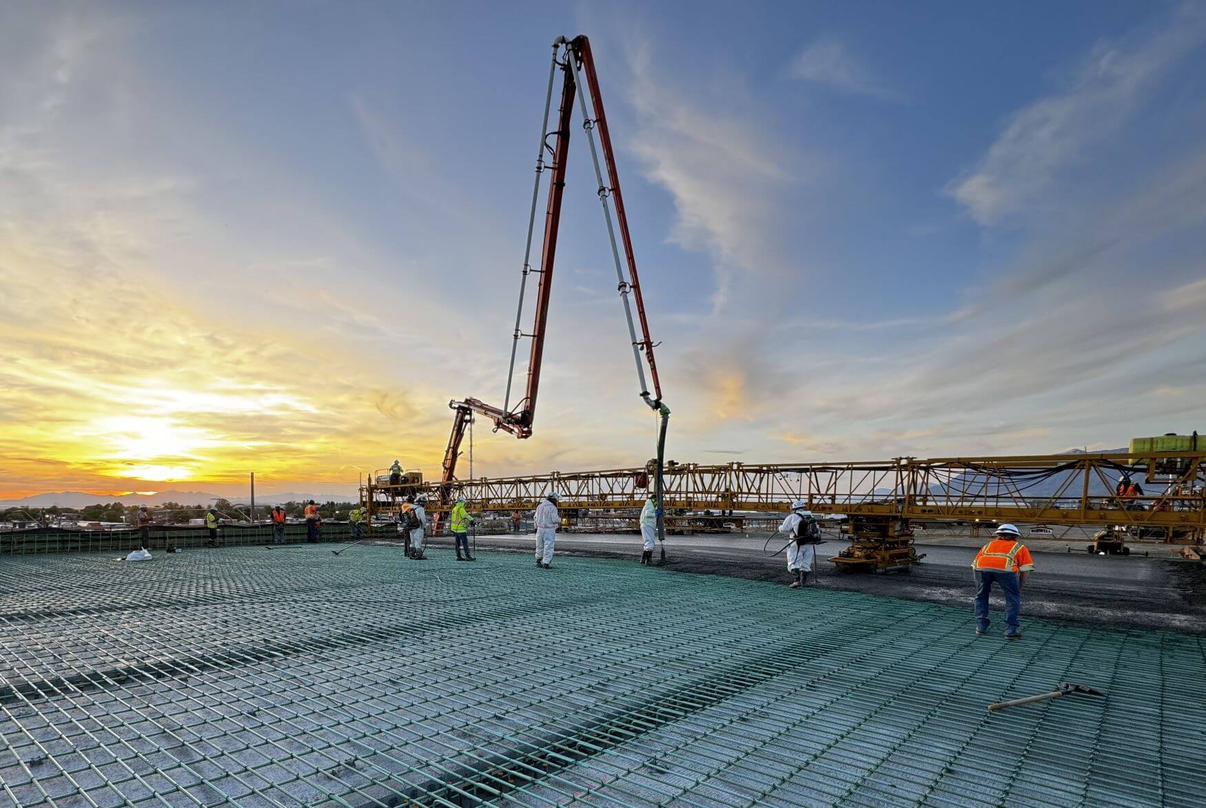 Construction work on a road at sunset