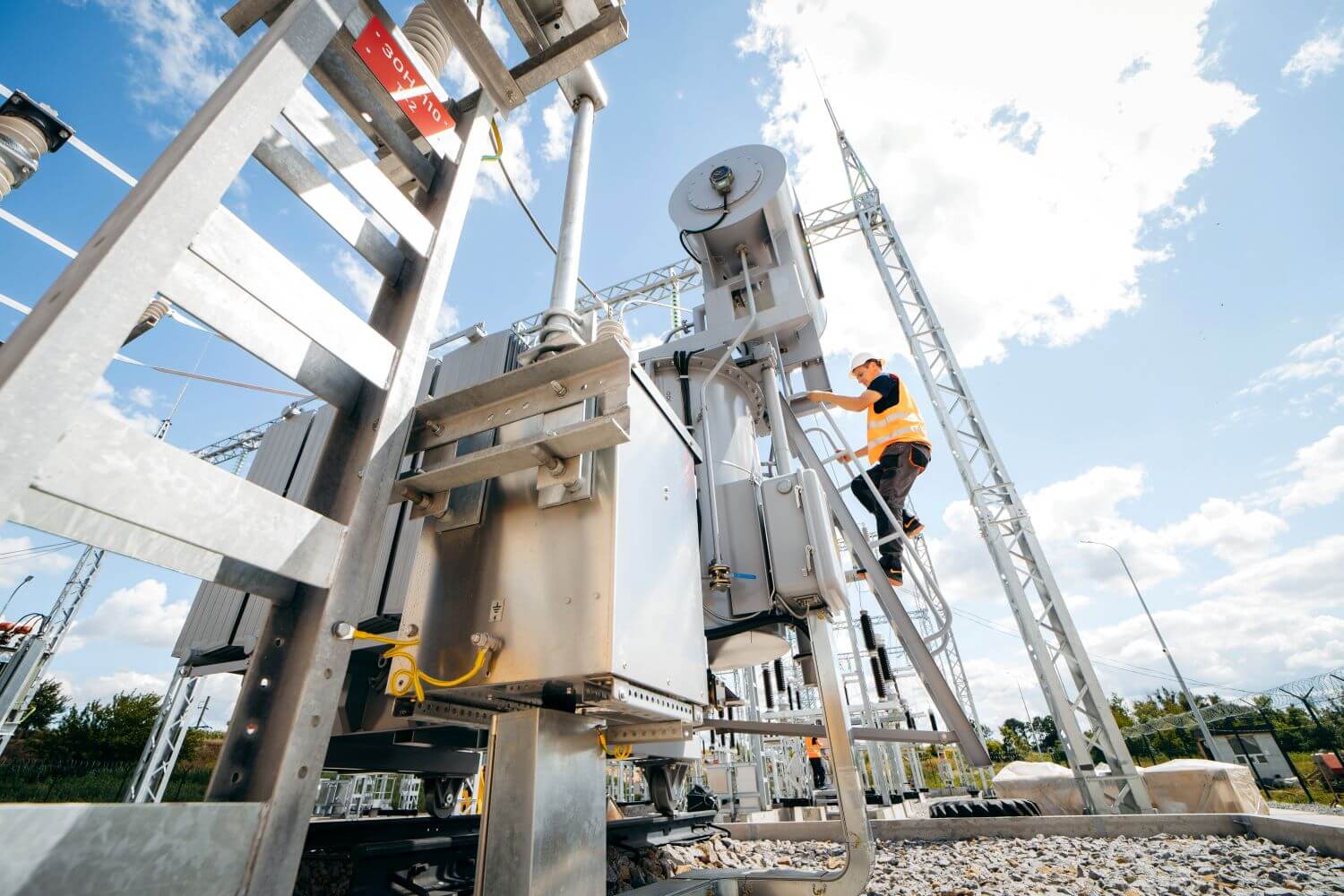 Engineer inspecting electrical systems under bright daylight