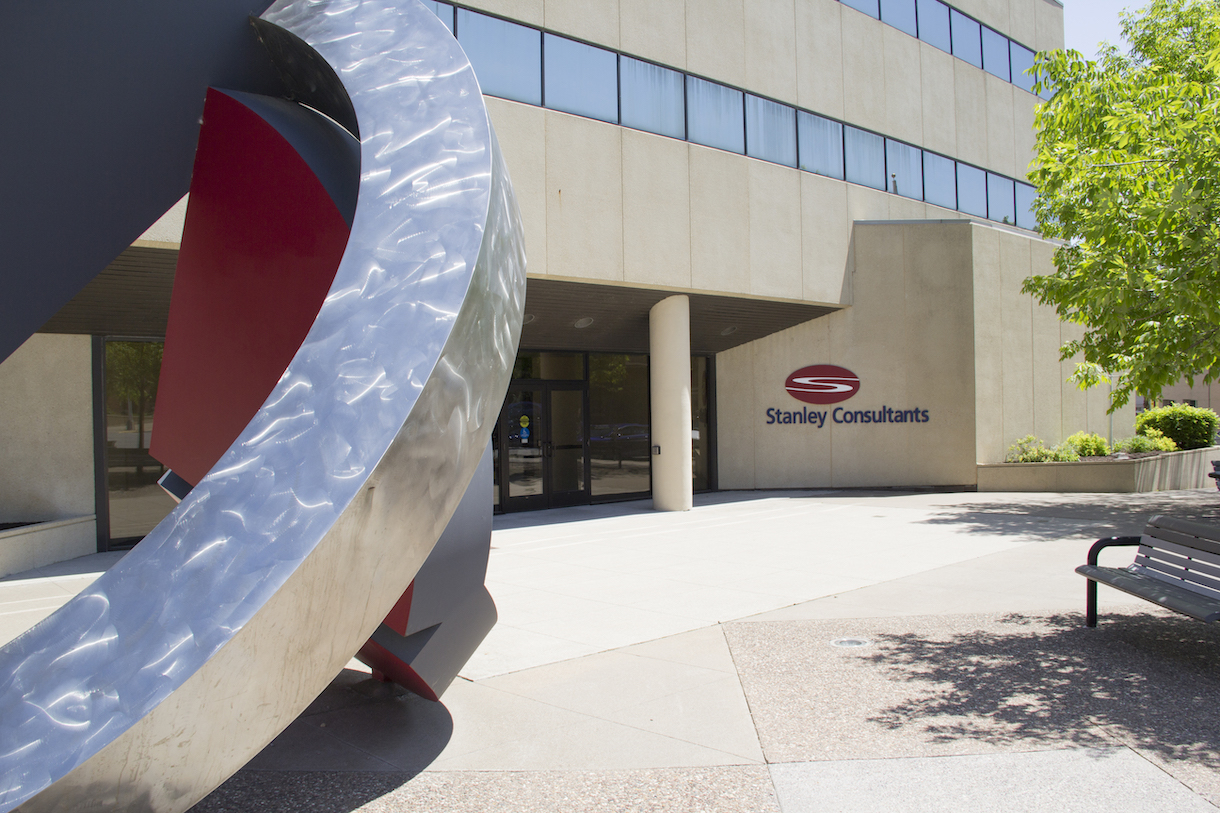Exterior view of Stanley Consultants' headquarters in Muscatine, Iowa, featuring an abstract sculpture near the entrance. Exterior view of Stanley Consultants' headquarters in Muscatine, Iowa, featuring an abstract sculpture near the entrance.