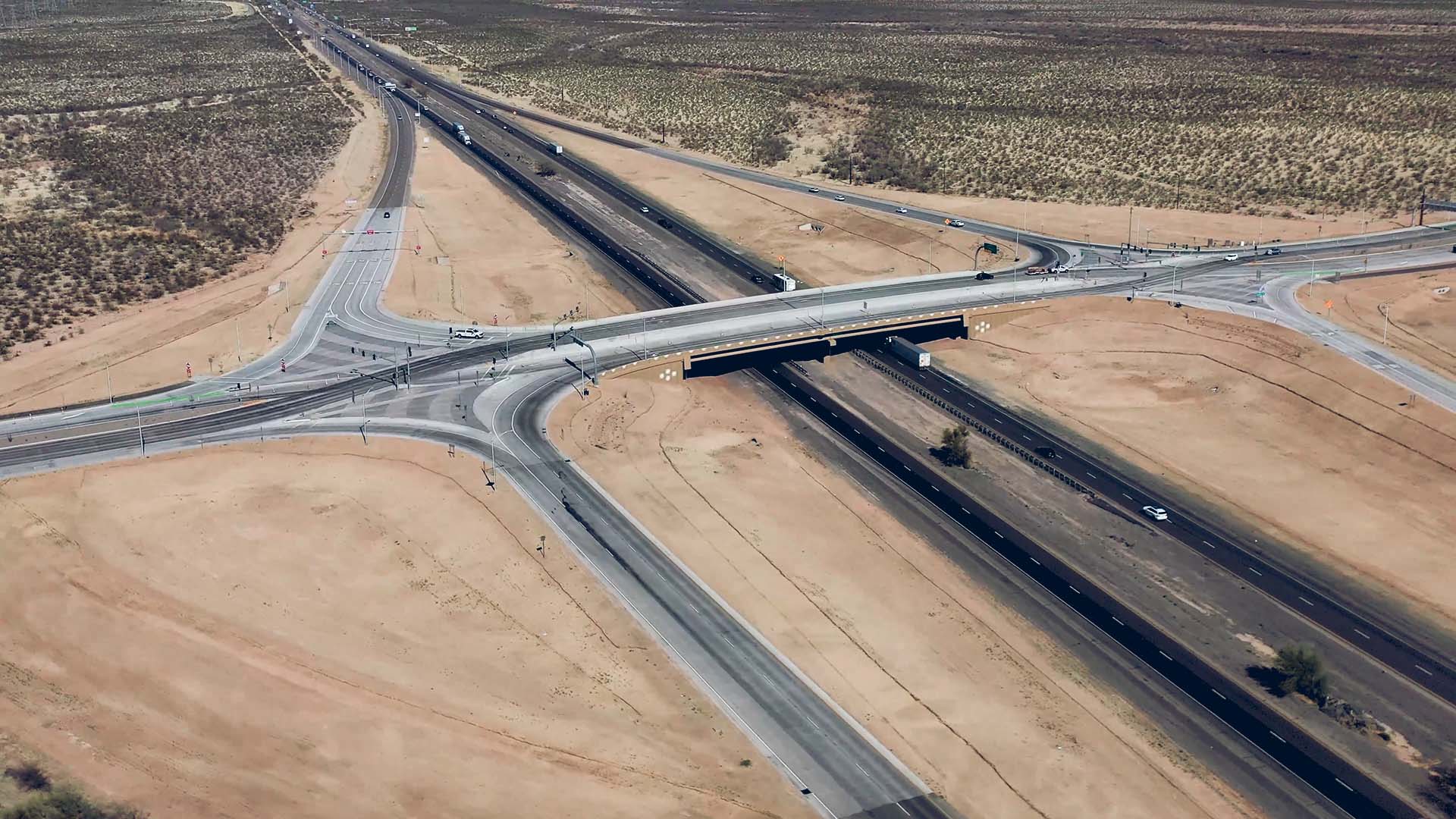 Overhead shot of a highway and off ramps in a desert