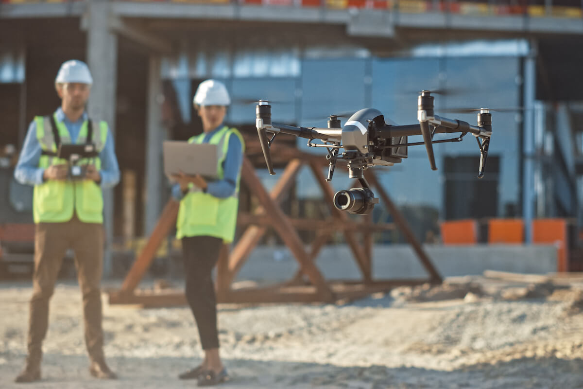 Engineers watching a drone on site